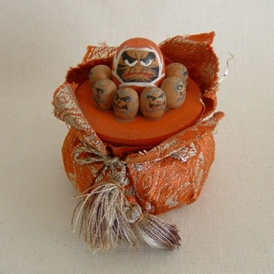 Daruma Dolls on Brocade Covered Pot